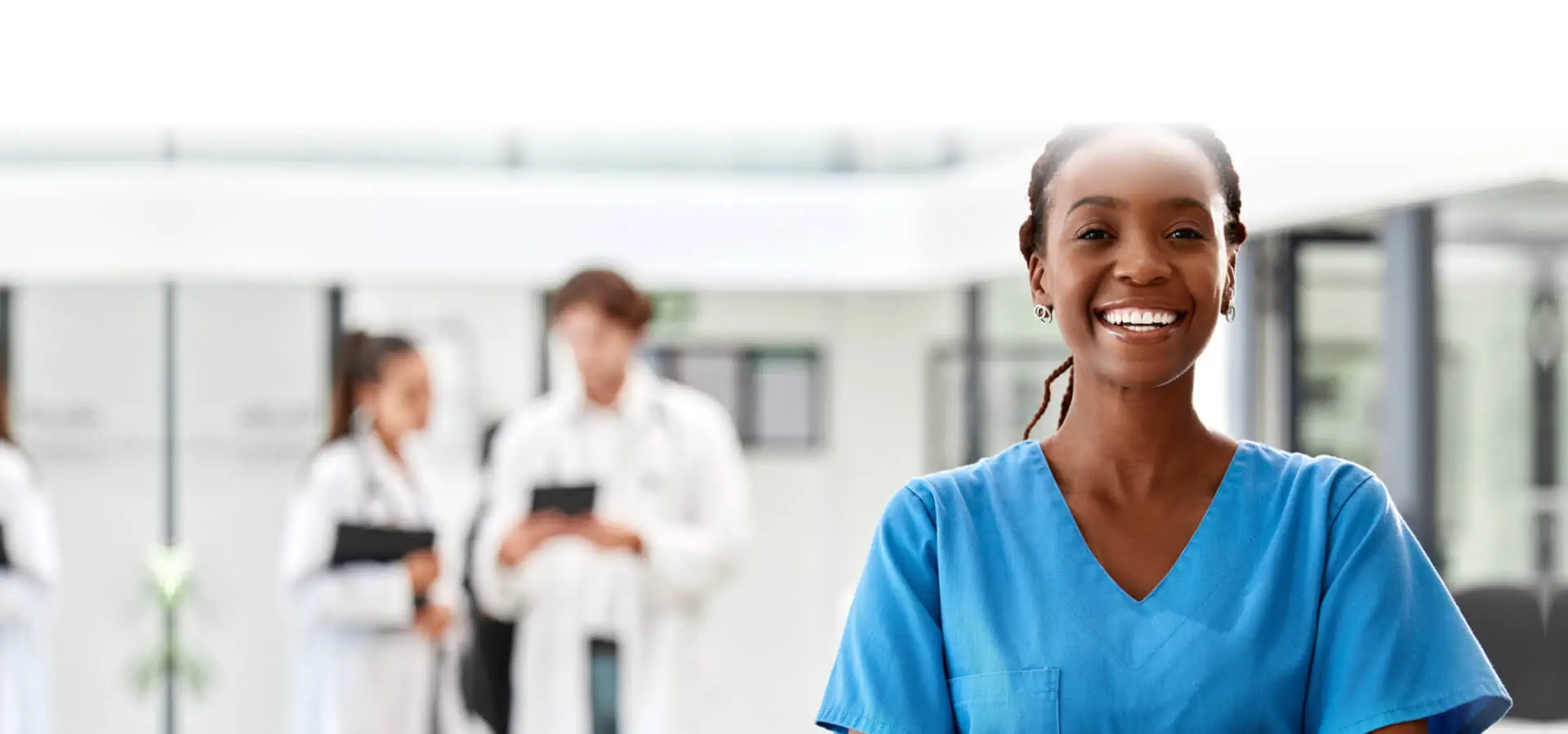 Smiling nurse in blue scrubs