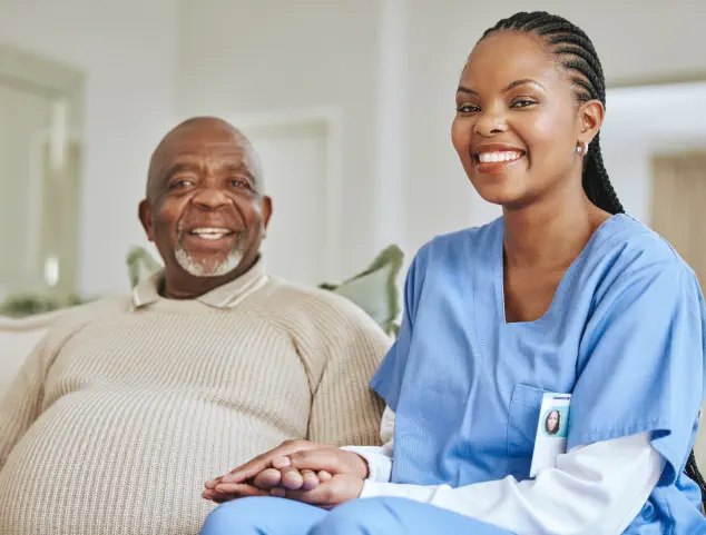 caregiver and elderly man smiling